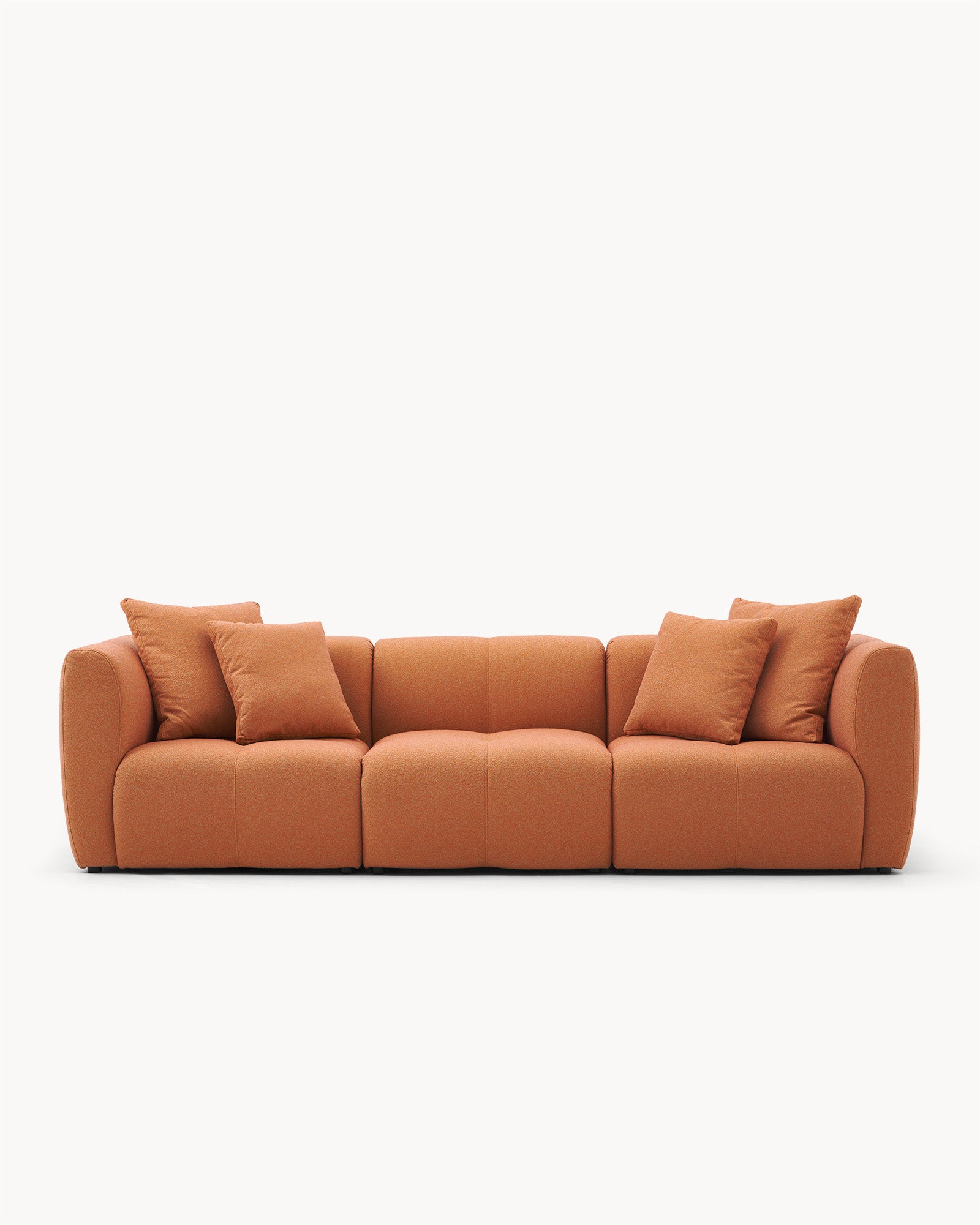 Sofa modułowa AURA (3 el.) - widok z przodu na modułową sofę z poduszkami, o zaokrąglonych kształtach.